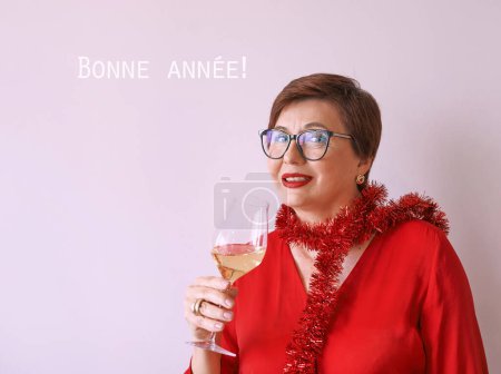 Photo for Stylish mature senior woman in red blouse with glass of white wine celebrating new year. Fun, party, style, lifestyle, alcohol, celebration concept - Royalty Free Image