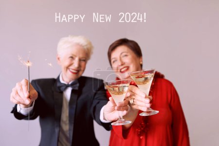Photo for Two beautiful stylish mature senior women celebrating new year. Fun, party, style, celebration concept - Royalty Free Image
