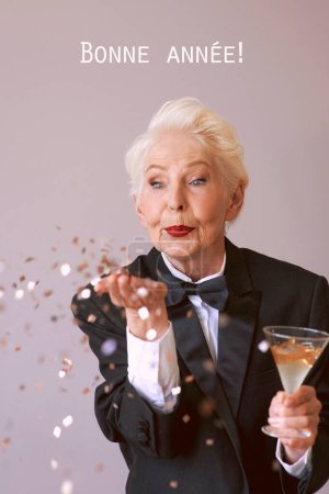 Photo for Stylish mature senior woman in tuxedo celebrating new year. Fun, party, party is over, style, celebration concept - Royalty Free Image