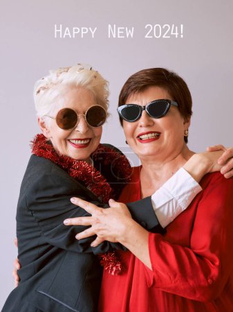 Photo for Two beautiful stylish mature senior women celebrating new year. Fun, party, style, celebration concept - Royalty Free Image