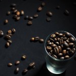 coffee beans in a glass on a black background
