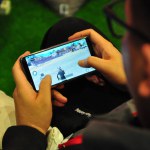 a man is playing a game on his cell phone