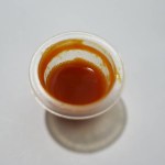 cup of chili sauce on a white background