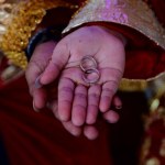 a pair of rings on the hands of the bride and groom