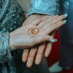 a pair of ring on the hands of the bride and groom