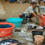 jakarta, indonesia- august 26, 2016: portrait of the capital's poor people washing clothes