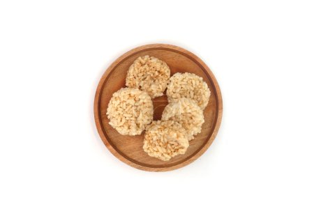 Rengginang or Rangginang, Traditional Indonesian Rice Crackers, made from rice or sticky rice. Savory and crunchy. Served on a wooden plate and isolated on a white background.