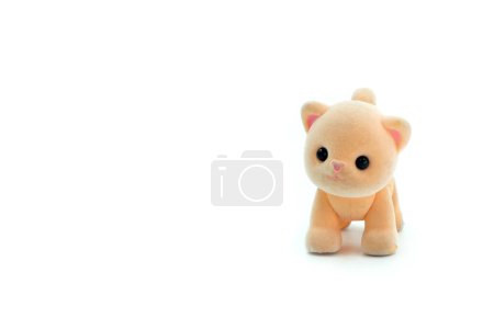 Close-up of a miniature toy cat on a white background. Copyspace can be used for your text.