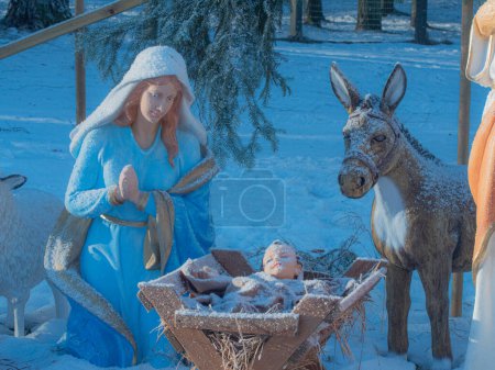 Photo for Nativity scene by the Christmas tree. Nativity scene, Adoration of the Magi. Nativity scene with figurines including Jesus, Mary, Joseph, sheep and Magi. - Royalty Free Image