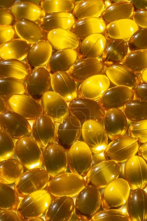 Photo for Omega capsules in sunlight. Sunlight reflects fish oil in capsules. The right diet - Royalty Free Image