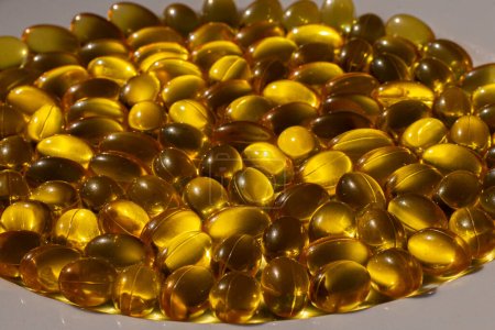 Photo for Omega capsules in sunlight. Sunlight reflects fish oil in capsules. The right diet - Royalty Free Image