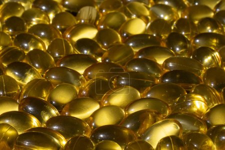 Omega capsules in sunlight. Sunlight reflects fish oil in capsules. The right diet