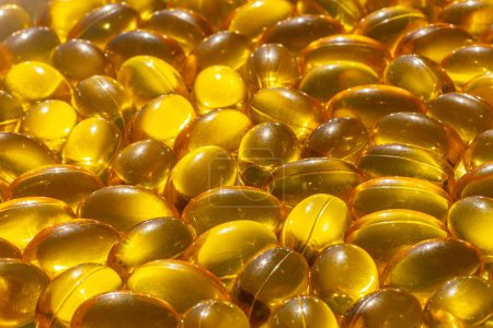 Omega capsules in sunlight. Sunlight reflects fish oil in capsules. The right diet