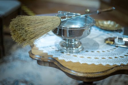 Photo for Liturgical vessels with holy water in the church. Broom for lighting in the church with holy water. Soft selective focus. Artificially created grain for the picture - Royalty Free Image
