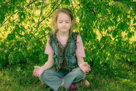 Photo for Girl is sitting in the shade relaxing and meditating - Royalty Free Image
