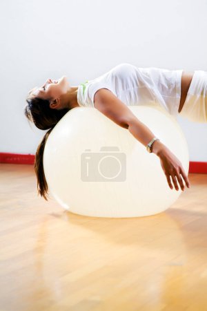 Photo for Woman in fit ball in health club - Royalty Free Image