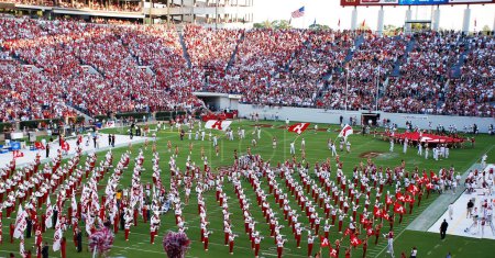Photo for Band on Field as players and cheerleaders run - Royalty Free Image