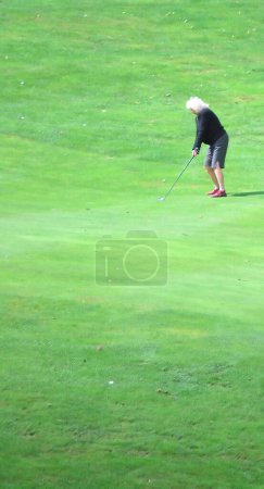 Photo for Golf senior woman playing golf in green grass - Royalty Free Image