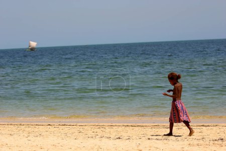 Photo for African american girl wandering along the beach - Royalty Free Image