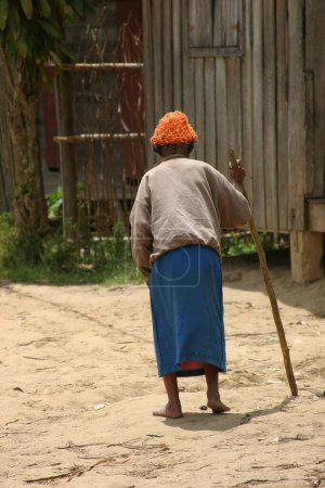 Photo for Old Asian lady walking in village - Royalty Free Image
