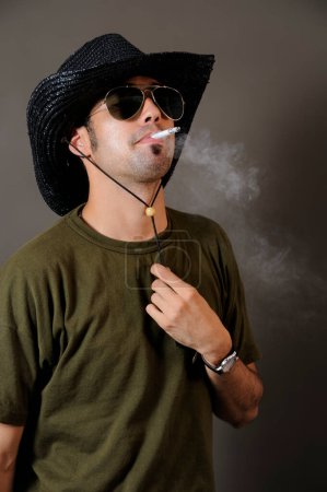 Photo for Smoking man posing in studio - Royalty Free Image