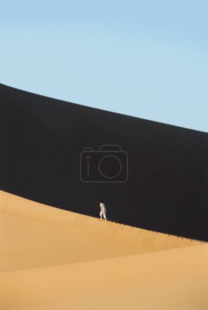Photo for Man outdoors walking in the desert - Royalty Free Image
