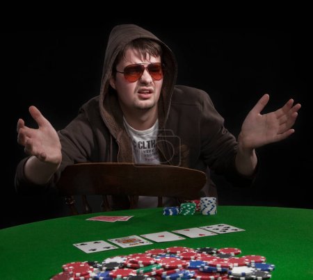 Photo for Man playing poker on black - Royalty Free Image