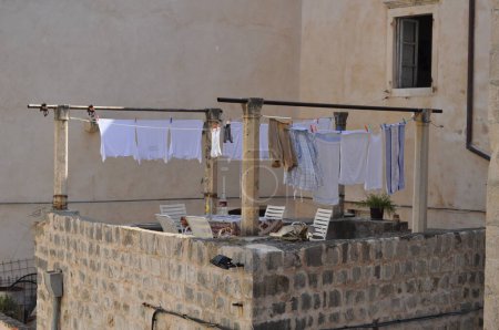 Photo for A vertical shot of a laundry hanging on the water well - Royalty Free Image