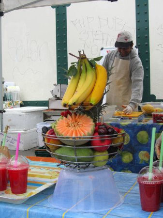Photo for Unidentified man at juice stall at Brick Lane Market on August 1 - Royalty Free Image