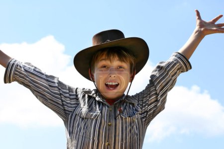 Photo for Boy in hat poding against sky - Royalty Free Image