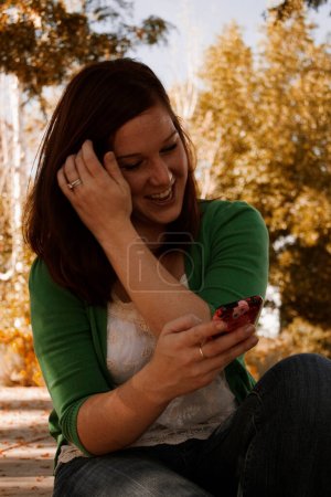 Photo for Young woman using smartphone - Royalty Free Image