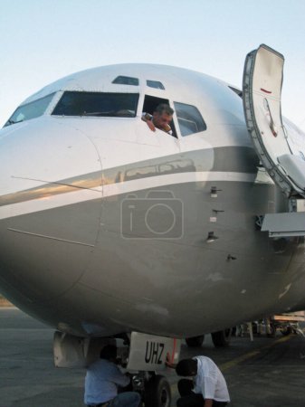 Téléchargez les photos : Pilote discutant avec les mécaniciens de la réparation des aéronefs - en image libre de droit