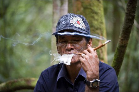 Photo for Man smoking a cigarette in the woods - Royalty Free Image