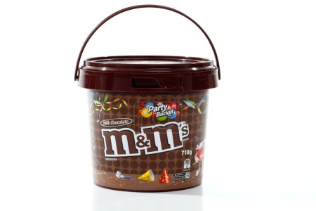 Photo for M&M's Party Bucket of confectionary candy on white background - Royalty Free Image