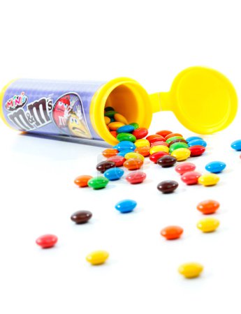 Photo for Container of M&M minis on white background - Royalty Free Image