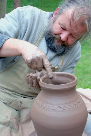 Photo for Front view of mature man making clay jug - Royalty Free Image
