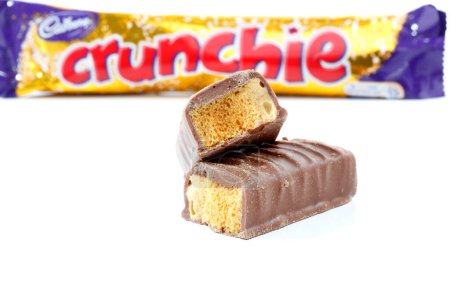 Photo for Cadbury Crunchie chocolate honeycomb bar on white background - Royalty Free Image