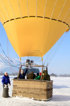 Téléchargez les photos : Ballon à gaz avec des personnes en hiver, lieu de voyage sur fond - en image libre de droit
