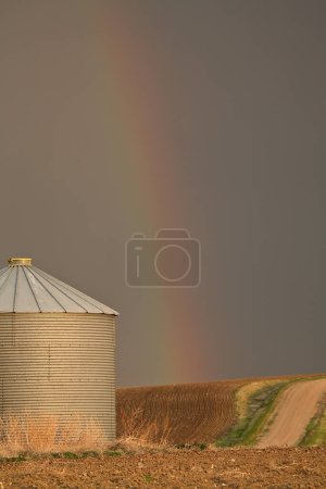 Photo for Rainbow touching down behind granary in Saskatchewan - Royalty Free Image