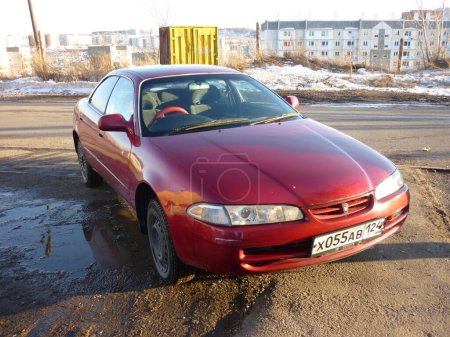 Photo for Toyota Sprinter Marino red car with buildings behind - Royalty Free Image