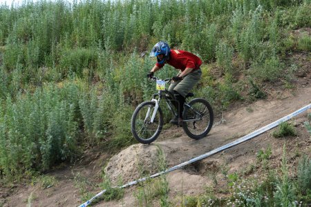 Photo for Man on mountain bike, competition for downhill concept - Royalty Free Image