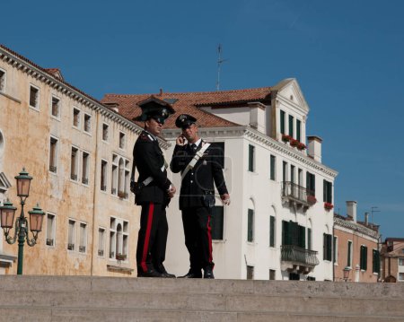 Photo for "Two carabinieri talking in Venice, Italy." - Royalty Free Image