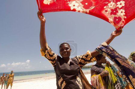 Photo for Kenya - October 21: an African woman sells pieces of cloth on the beach - Royalty Free Image