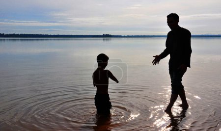 Photo for Father and son in river or lake - Royalty Free Image