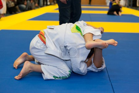 Photo for Children grappling during martial arts fight - Royalty Free Image