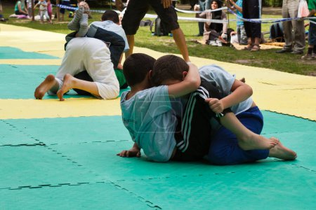 Photo for Children street wrestling on mat - Royalty Free Image