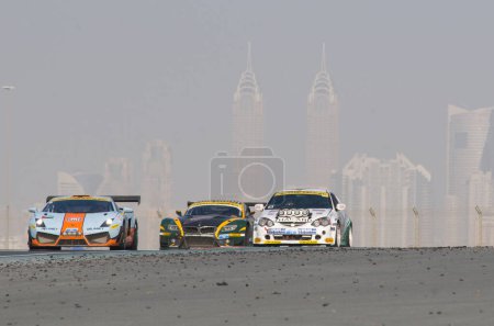 Téléchargez les photos : Courses de voitures de vitesse à la course de 24 heures à l'Autodrome de Dubaï le 14 janvier 2012 - en image libre de droit