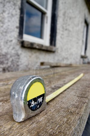 Photo for "builders diy tape measure at building site" - Royalty Free Image