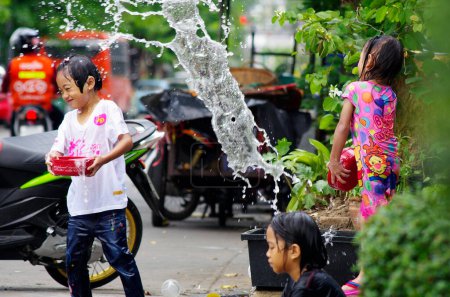 Photo for BANGKOK, THAILAND - APRIL 14 2012: Songkran (thai new year and water festival) is celebrated from april 13 to 15. people roam the streets and drench each other and passersby with water - Royalty Free Image