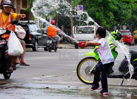 Photo for BANGKOK, THAILAND - APRIL 14 2012: Songkran (thai new year and water festival) is celebrated from april 13 to 15. people roam the streets and drench each other and passersby with water - Royalty Free Image